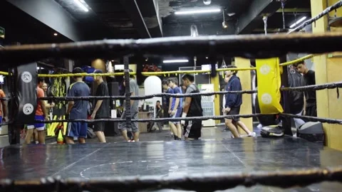 Group training boxing class inside gym ring with athletes practicing drills Stock Footage 332803036