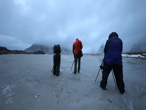 Group of travel photographers doing pictures in the shores of Norwegian Sea. Stock Footage