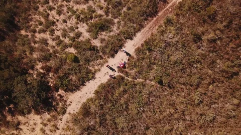 A group of trekkers rest on a path, pull up view from a drone Stock Footage 105241806
