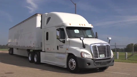 Group of trucks heading out from a container yard Stock Footage 99044099