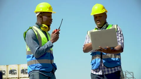 Group of two african american engineer  holding laptop computer talking wit.. Stock Footage 241717040