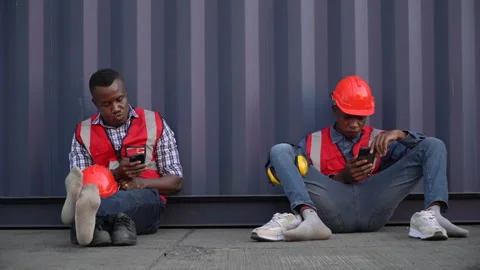 Group of two  african american worker take a break  using smartphone near C.. Stock Footage 242314311