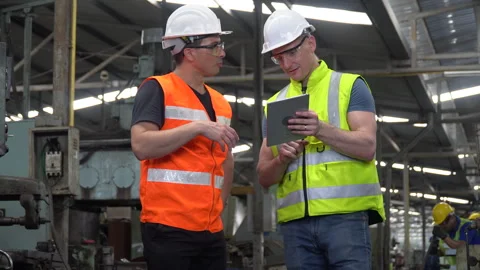 Group of two Engineer working with tablet taking together in industry factory Stock Footage 246987360