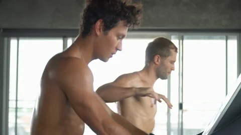 Group of two muscular man running on treadmill in fitness gym at sport club . Stock Footage 162802885