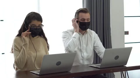 Group of two operator man and woman wearing protective face mask working with Stock Footage 158752006