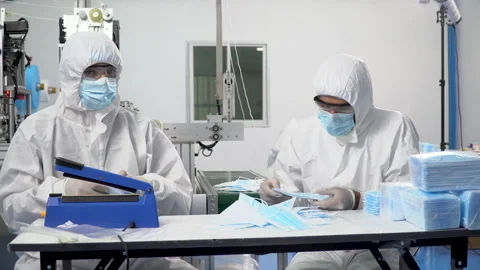 Group of two packer worker wearing ppe suite, face protective mask and glove Stock Footage 141409948