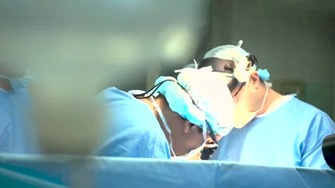 A group of uniformed surgeons working in the operating room. Focused surgeons Stock Footage 263894986
