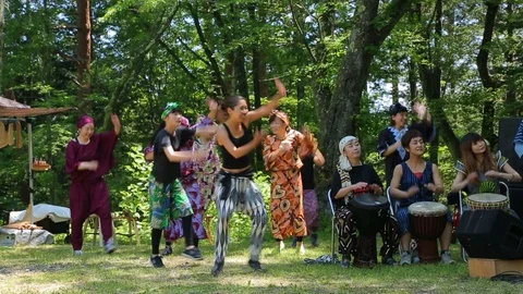 Group of unknown dancers dancing African dances at summer festival. Stock Footage 107990656