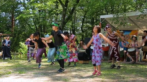 Group of unknown dancers dancing African dances at summer festival. Stock Footage 107995242