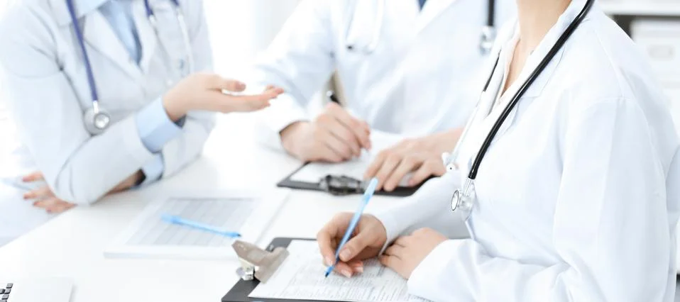 Group of unknown doctors discussing problems to stop coronavirus pandemic while Photos