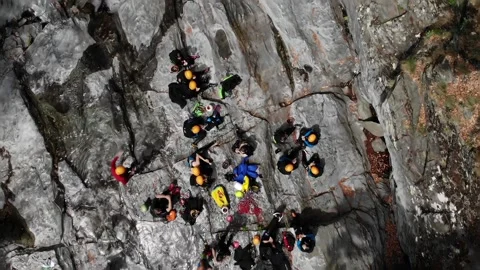 A group of unrecognizable people get ready to go canyoning. A tour group on a Stock Footage 201524785