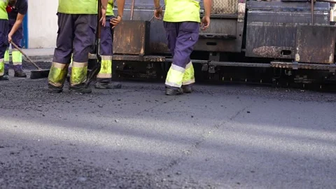 Group of unrecognizable road workers with an asphalt paving machine view fro Stock Footage 253230873