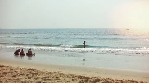 A group of unrecognized people on the beach. Calm sea surf. Stock Footage 83023856