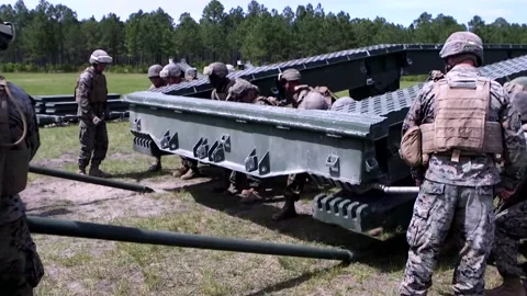 Group of U.S. Soldiers Installing a Section of Steel Structure Stock Footage 130358785