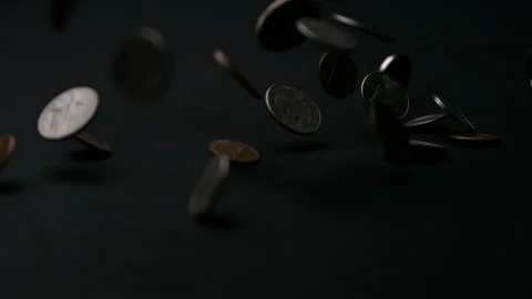 A Group of Usd Coins Falling on a Black Table Stock Footage 270387782