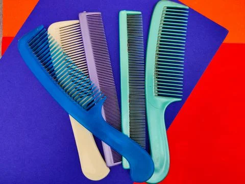 Group of used combs isolated on red and blue background Stock Photos