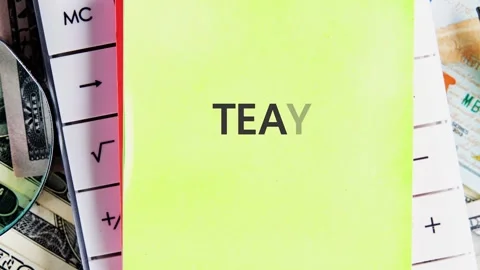 A group uses sticky notes to form a word on a desk filled with cash and a ruler. Stock Footage 341850911