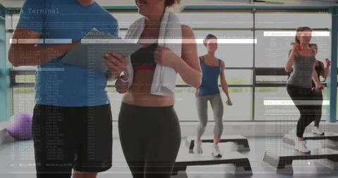 Group using smartphones while stepping on platforms in fitness gym, showing Stock Footage 307549959