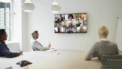 Group Using Video Conferencing technology in office for video call with Video stock 127036731