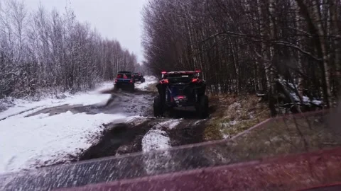 A group of UTV buggies drive through mud and puddles Stock Footage 177041947