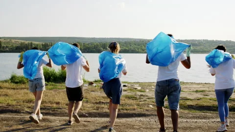 Group of volunteers multiethnic on the beach side beside the lake running Stock Footage 144061446
