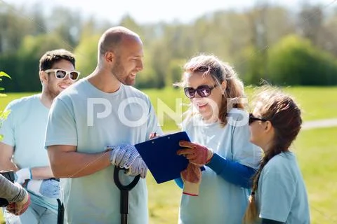 Group of volunteers planting trees in park Stock Photos