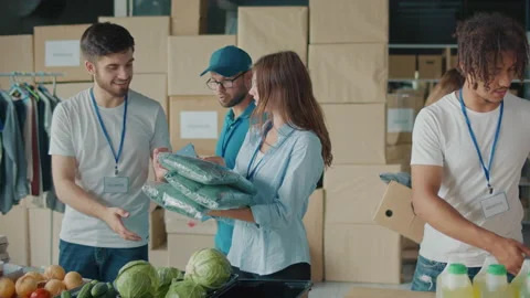 Group of Volunteers Preparing Humanitarian Aid for Poor People in Need. Stock Footage 220625083