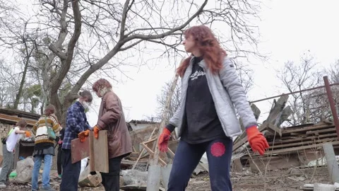 Group of volunteers sorting debris at the russian rocket crash site Stock Footage 270170748