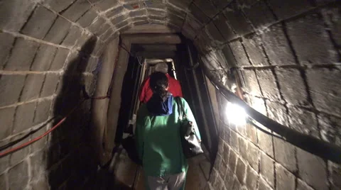 Group walking in a small salt mine tunnel Stock Footage 52311211