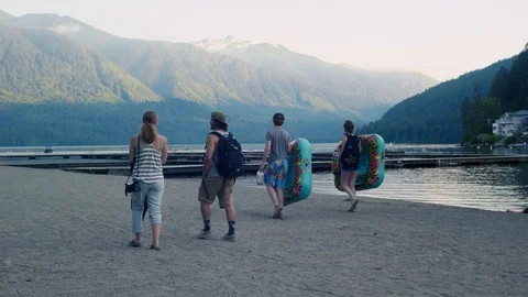 A group walks down the beach at Cultus Lake BC Stock Footage 89913295