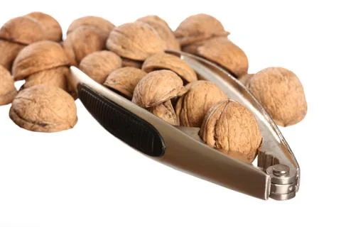 Group of walnuts and a nutcracker isolated on white Stock Photos