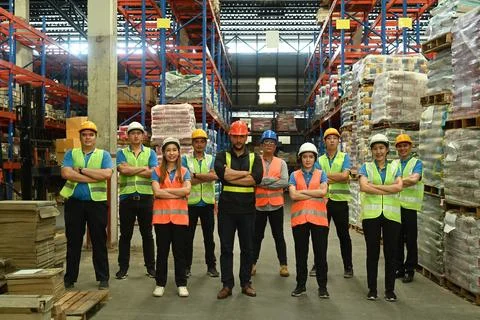 Group of warehouse worker standing in line with arms crossed together at 스톡 사진