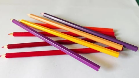 Group of warm tone colored pencils on white background. Stock Footage 338009662