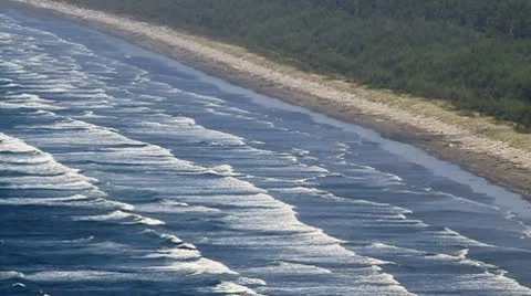 Group of waves coming ashore on beach zoomed in Stock Footage 10747184