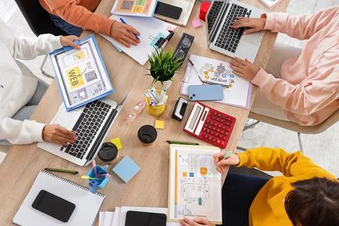 Group of web designers working at desk in office, top view Stock Photos