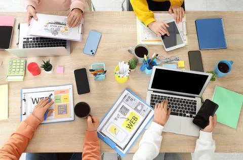 Group of web designers working at desk in office, top view Stock Photos