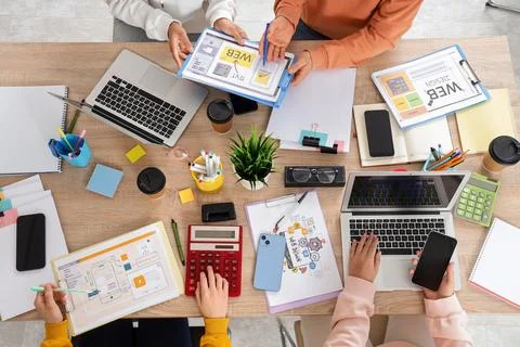 Group of web designers working at desk in office, top view Stock Photos