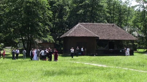 Group of wedding guests sit next to a house and photographing on grass 38 Stock Footage