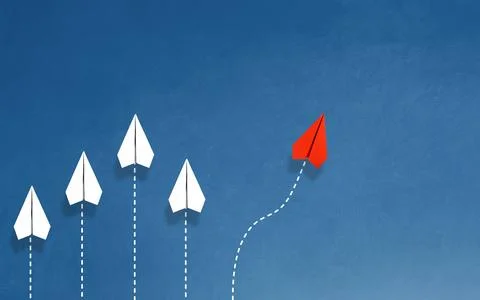 Group of white paper planes in one direction and one red paper plane pointi.. Stock Photos