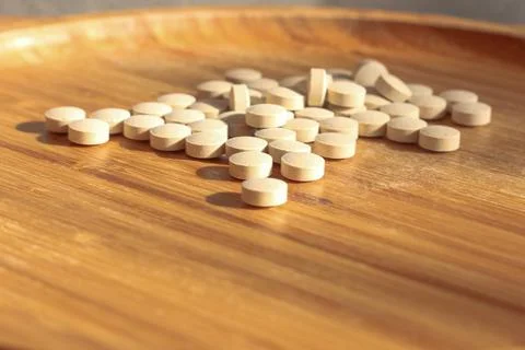 Group of white pills on the table Stock Photos