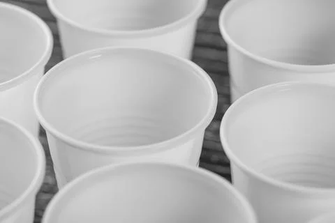 A group of white plastic cups mounted on a black table Stock Photos