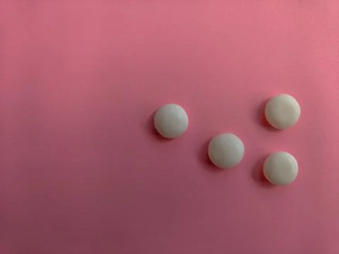 Group of White Round Candy Mints on Pink Background Stock Photos