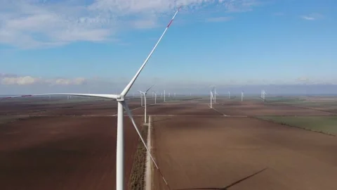 Group of wind driven generators stands among wide fields Stock Footage 149650834