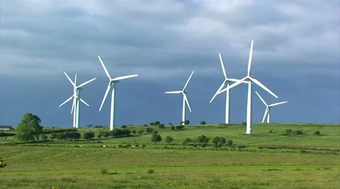 Group of wind mills in front of a dark cloud Stock Footage 39996578