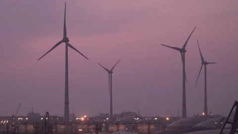 A group of wind power generators generates energy in the evening. Stock Footage 140390651