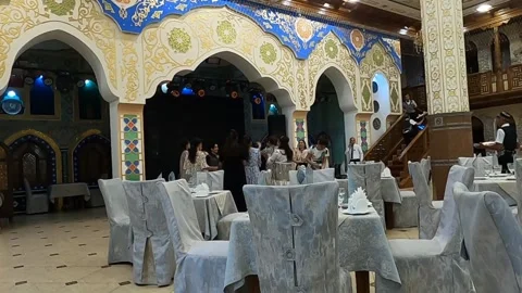 Group of women dancing on stage inside a luxury Uzbek restaurant Stock Footage 336846218