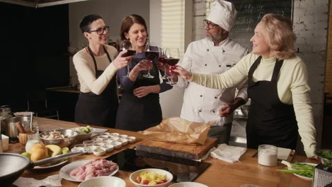 Group of Women Drinking Wine with Chef After Completing Cooking Master Class Stock Footage 332571237