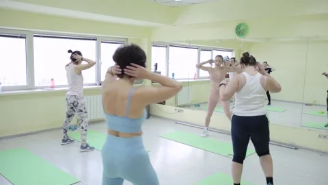 A group of women having workout in a hall Stock Footage 169587635