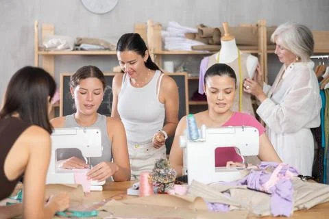 Group of women sew and work with mannequin at master class 库存照片