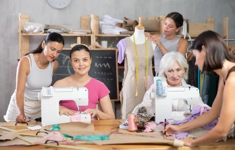 Group of women sew, draw pattern and work with mannequin Stock Photos